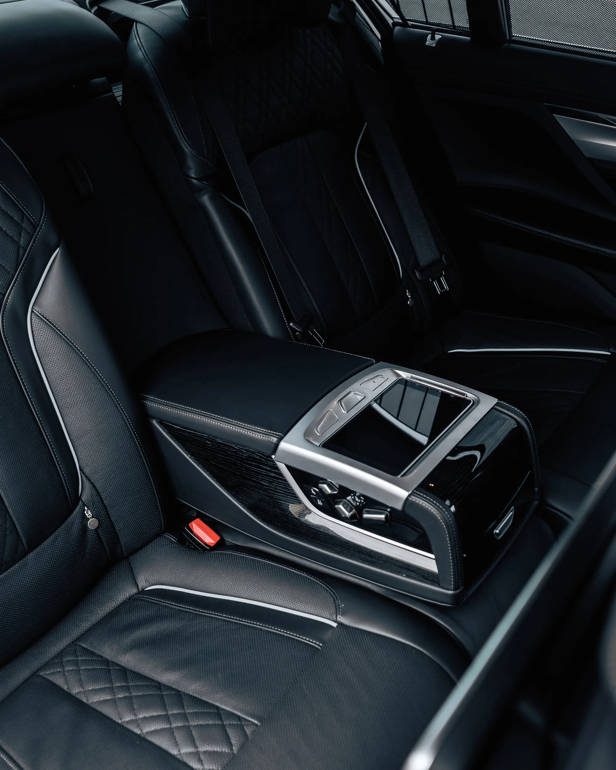 Rear passenger interior of BMW 7 Series luxury class vehicle with premium seating